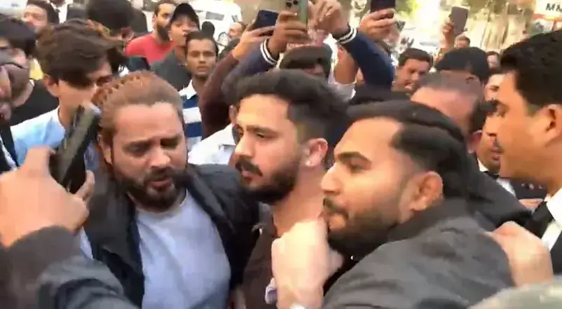 Content creators Rajab Butt and Nadeem Mubarak, also known as Nani Wala, surrounded by a crowd at the Karachi sessions court central on December 29. — Screengrab from video provided by author Content creators Rajab Butt and Nadeem Mubarak, also known as Nani Wala, surrounded by a crowd at the Karachi sessions court central on December 29. — Screengrab from video provided by author