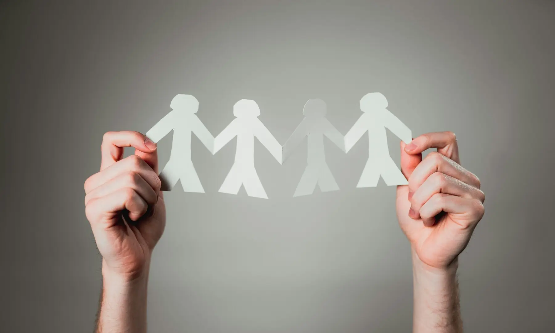 Hands holding a paper chain. — Andrew Moca / Unsplash