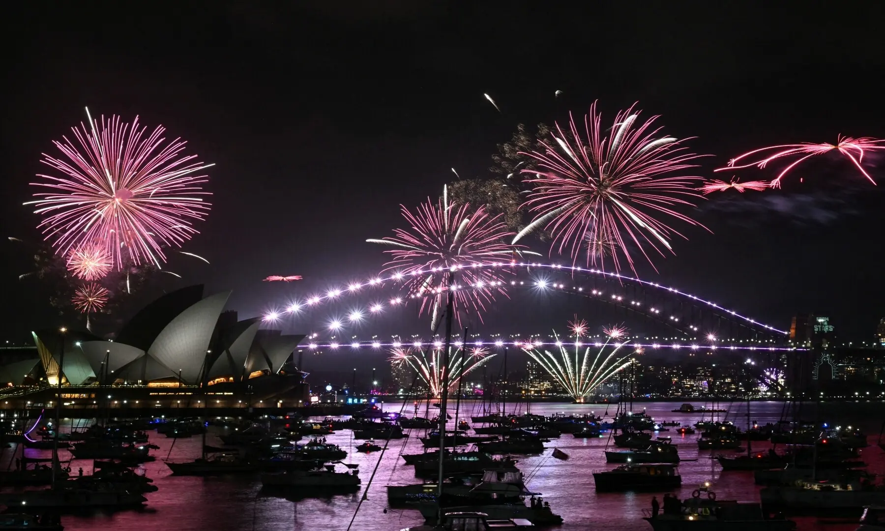 Fireworks light up the midnight sky over Sydney Harbour Bridge and Sydney Opera House during New Year’s Day celebrations in Sydney on January 1, 2026. — Saeed Khan / AFP