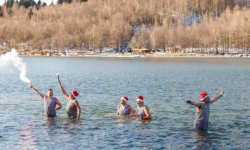 People celebrate the new year early at noon, on New Year’s Eve, by Lake Bajer in Fuzine, Croatia on December 31. — Reuters