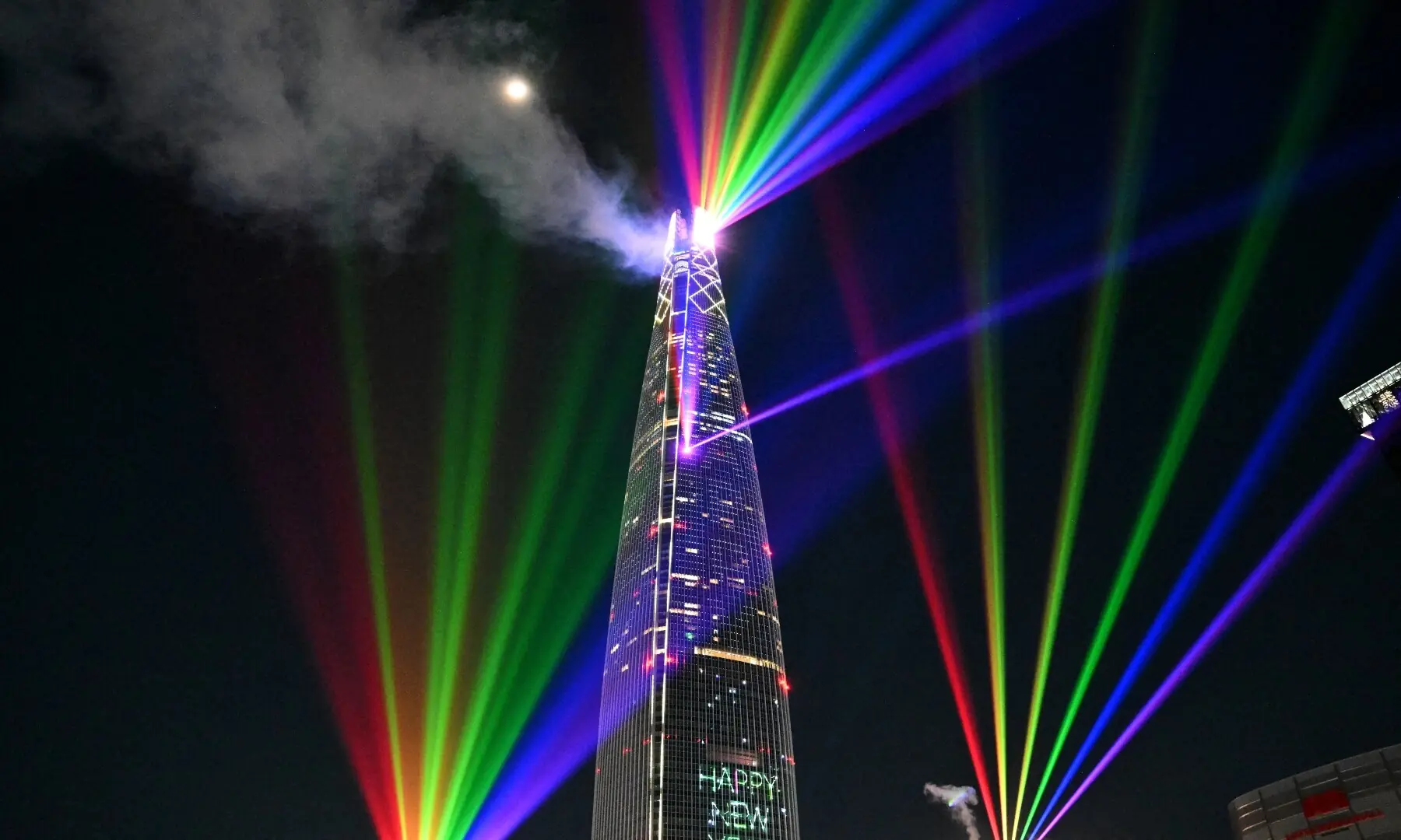Laser lights illuminate the midnight sky over the Lotte World Tower, South Korea&rsquo;s tallest building in Seoul during New Year&rsquo;s Day celebrations on January 1, 2026. &mdash; Jung Yeon-je / AFP
