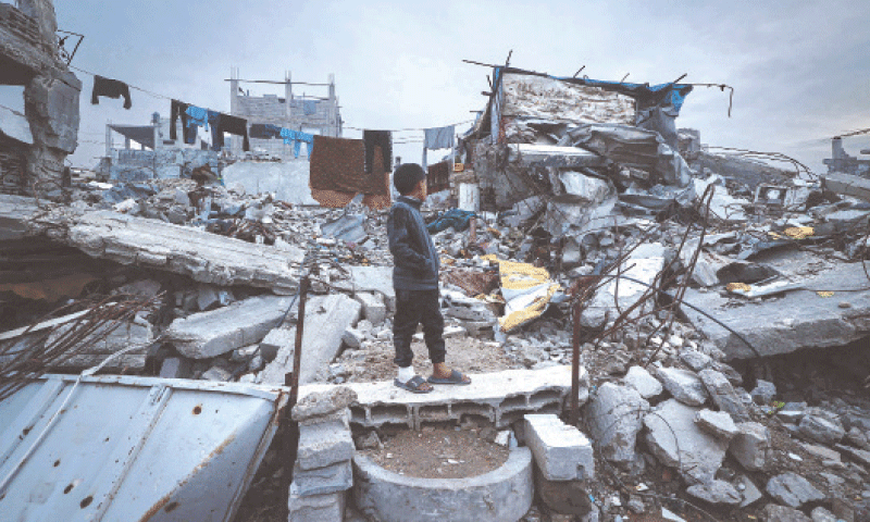 A displaced Palestinian boy stands on the debris of destroyed buildings in the Bureij refugee camp. The Hamas-run health ministry says more than 70,000 Palestinians have been killed since October 2023.&mdash;AFP