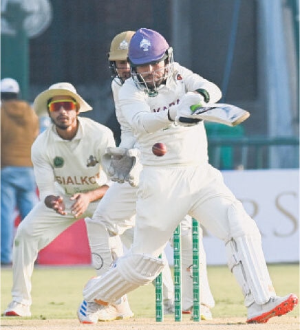 KARACHI Blues&rsquo; batter Usman Khan plays a stroke during the Quaid-e-Azam Trophy final against Sialkot at the Gaddafi Stadium on Monday.&mdash;Courtesy PCB