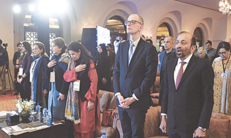 PARTICIPANTS rise for the national anthem.&mdash; Photo By Tanveer Shahzad