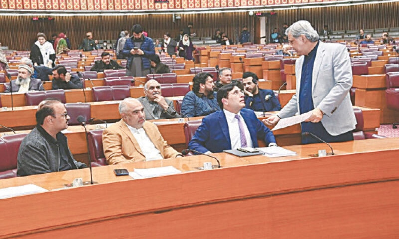 Law Minister Azam Nazeer Tarar interacts with Barrister Gohar Ali Khan and other PTI legislators during the National Assembly session on Monday.&mdash;White Star