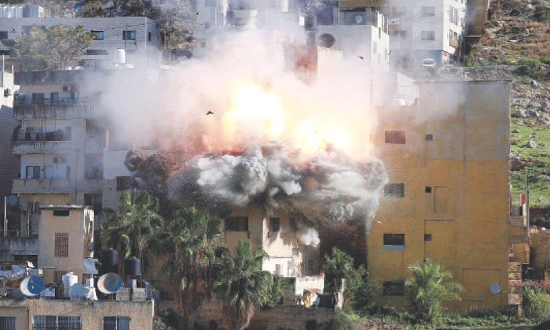 Smoke billows as Israeli forces demolish the house of Abdul Karim Snobar, who was detained earlier this year after being accused of plotting bus bombings in the occupied West Bank city of Nablus.&mdash;AFP