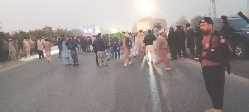 PTI activists block Peshawar Motorway in Swabi on Tuesday. &mdash; Dawn