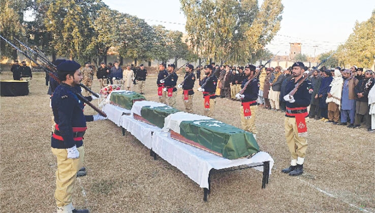 SECURITY officials offer funeral prayers for police personnel who were martyred in the Dera Ismail Khan attack.—AFP