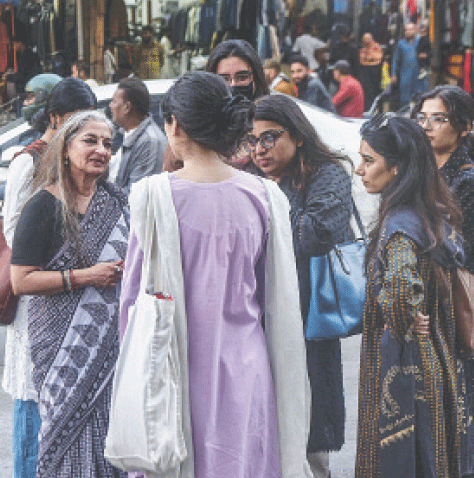 With all roads leading to the Karachi Press Club blocked by authorities, rights activist Sheema Kermani speaks with participants of the Aurat March on a street near the KPC.—Fahim Siddiqi / White Star