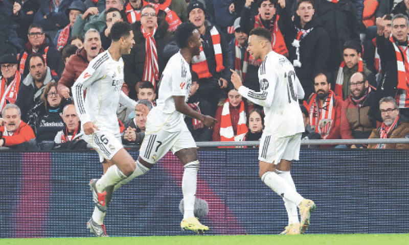 REAL Madrid’s Kylian Mbappe (R) celebrates with team-mates Vinicius Jr (C) and Jude Bellingham after scoring against Athletic Bilbao during their
La Liga match at San Mames.—Reuters REAL Madrid’s Kylian Mbappe (R) celebrates with team-mates Vinicius Jr (C) and Jude Bellingham after scoring against Athletic Bilbao during their
La Liga match at San Mames.—Reuters