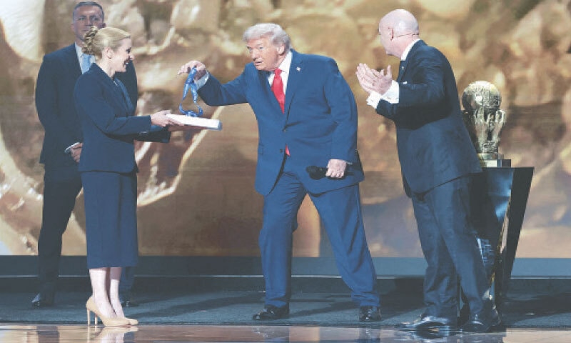 WASHINGTON: US President Donald Trump receives a medal as he is awarded the inaugural &lsquo;FIFA Peace Prize&rsquo; by Gianni Infantino during the World Cup 2026 draw.&mdash;Reuters
