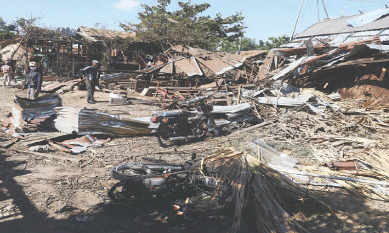 VILLAGERS inspect their damaged homes after the bombardment by Myanmar’s military.—AFP VILLAGERS inspect their damaged homes after the bombardment by Myanmar’s military.—AFP