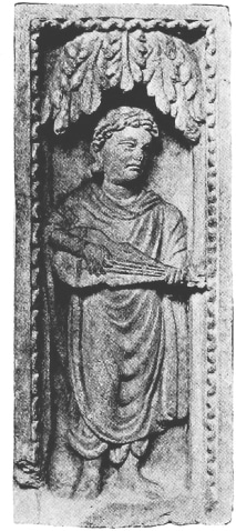 A Gandharan relief sculpture depicting a musician playing a lute