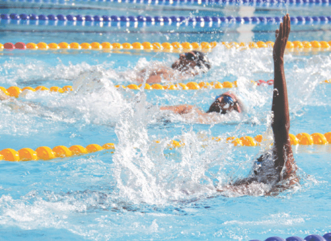 SWIMMERS compete during the men’s 200m backstroke final of the National Games at the KMC Sports Complex on Tuesday.—Shakil Adil/White Star