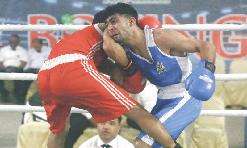 NAVEED Ashraf Waseem (R) of Pakistan Air Force and Navy&rsquo;s Aurangzeb trade blows during National Games their bout on Wednesday.&mdash;Shakil Adil/White Star