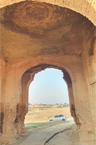 The interior view of the main gate show worn-out bricks and cracking ceiling.