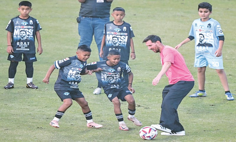 NEW DELHI: Argentina&rsquo;s legend Lionel Messi plays football with children during his GOAT Tour at the Arun Jaitley Stadium on Monday.&mdash;AFP