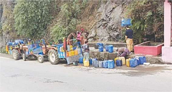 Locals fill water containers at a spring in Bely Baba, Alpuri. &mdash; Dawn
