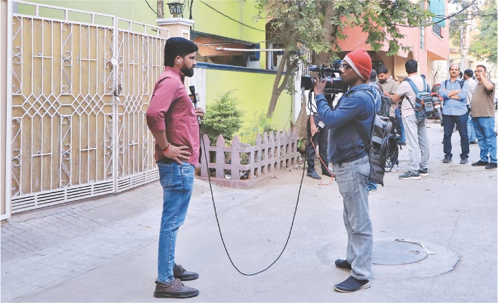 HYDERABAD: Media personnel work in front of the family home of the suspected Bondi Beach gunman.&mdash;Reuters