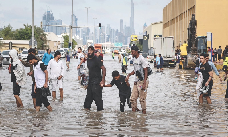 DUBAI: People wade through floodwaters after heavy rains flooded the emirate. Police urged residents to stay indoors unless it was ‘absolutely necessary’ as heavy rainfall was expected in the desert country, which also saw record downpours last year.—AFP DUBAI: People wade through floodwaters after heavy rains flooded the emirate. Police urged residents to stay indoors unless it was ‘absolutely necessary’ as heavy rainfall was expected in the desert country, which also saw record downpours last year.—AFP