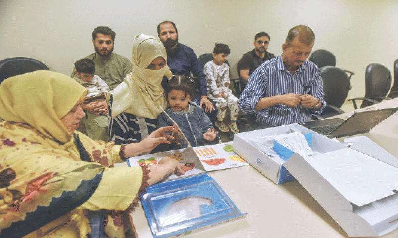 Zunaisha is engaged in a learning activity as IMRA team prepares to activate her hearing system.—Fahim Siddiqi / White Star Zunaisha is engaged in a learning activity as IMRA team prepares to activate her hearing system.—Fahim Siddiqi / White Star