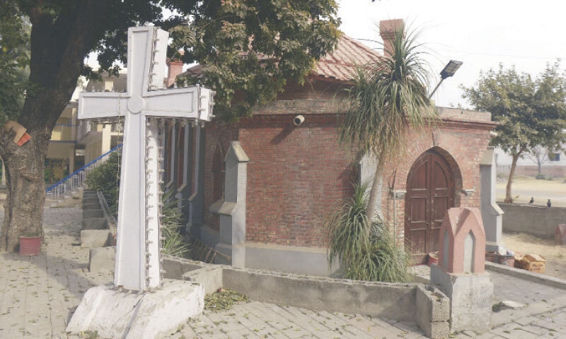 The cross fixed in the lawn besides the chapel which was used for prayers during the construction of the main building in 1852. — Photos by Mohammad Asim