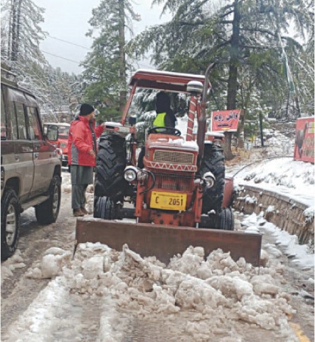 A machine clears Shogran road in Kaghan Valley on Monday. &mdash; Dawn