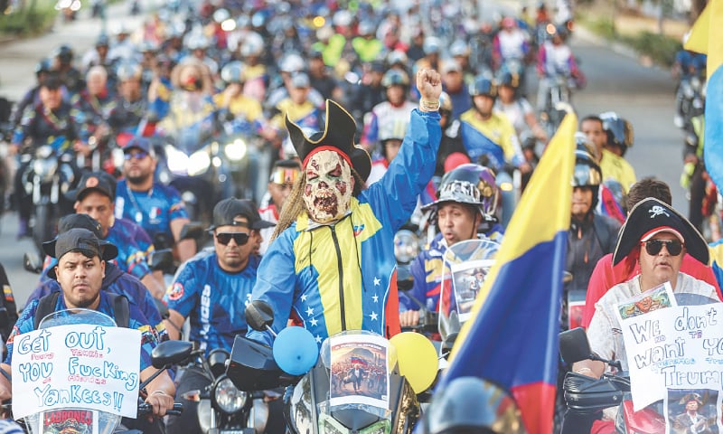 CARACAS: Motorcyclists supporting Venezuelan President Nicol&aacute;s Maduro participate in a motorcade to protest against the United States. Dressed as pirates, dozens of motorcyclists rode to protest the seizure of ships carrying Venezuelan oil.&mdash;AFP
