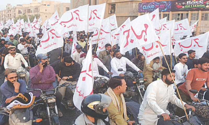 Participants of a rally pass through the Liaquatabad flyover.
&mdash;Fahim Siddiqi / White Star