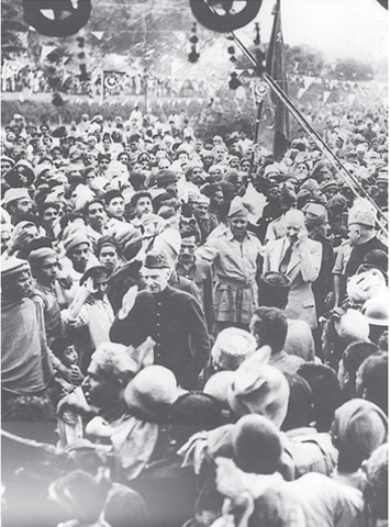 THE Quaid surrounded by massive, fawning crowds as he arrives in Peshawar to address a public meeting.