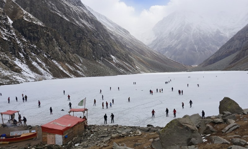 Tourists walk on the frozen Andrab Lake in Kalam Valley, Swat. &mdash; Dawn