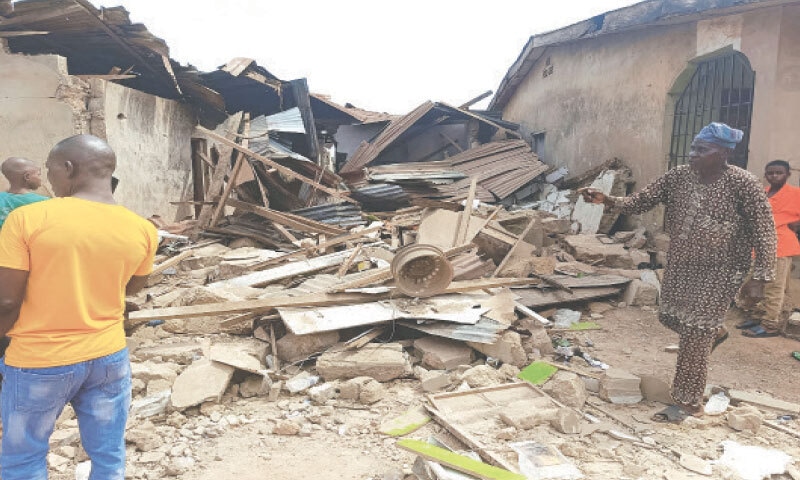 LOCALS inspect the damage to a building in Offa, Kwara State, after US forces launched strikes against Islamic State militants in Nigeria.&mdash;Reuters