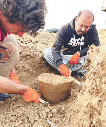    Archaeologists carry out excavation at Bhir Mound remains on Friday.—Dawn   