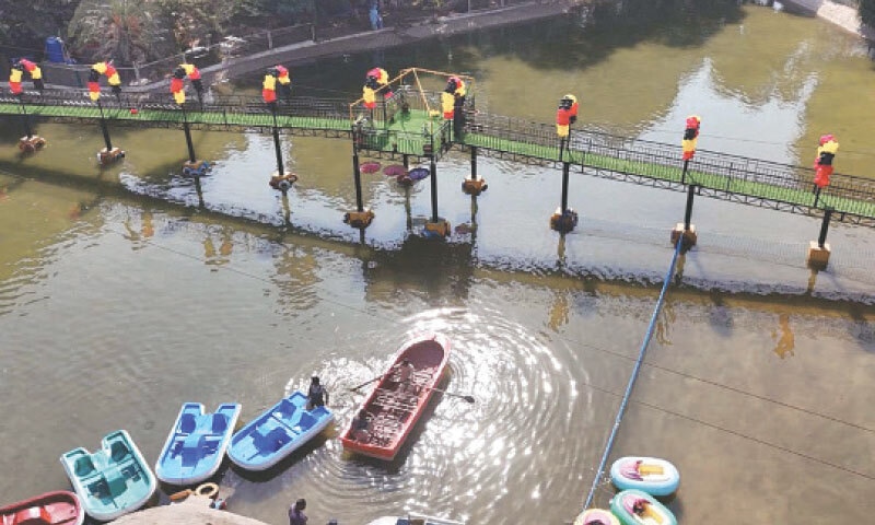 Boats are tied to the dock in the renovated pond at the Karachi Zoological Gardens, where a new pedestrian bridge, decorated with colorful balloons, now spans the water. &mdash;PPI