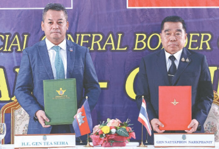 Cambodian Defence Minister Tea Seiha and his Thai counterpart Nattaphon Narkphanit pose with ceasefire documents.—AFP