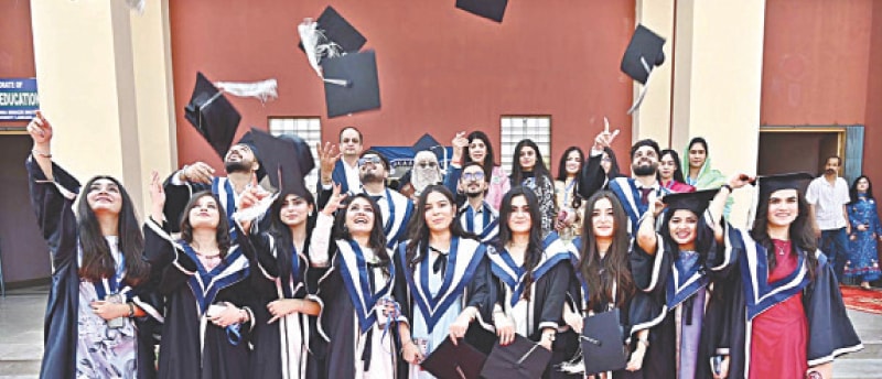 LARKANA: Students toss their caps in the air in celebration during the annual convocation.&mdash;APP