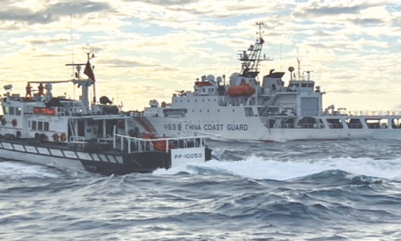 A Taiwanese coast guard ship (left) sails beside a Chinese ship in waters off Taiwan. —AFP A Taiwanese coast guard ship (left) sails beside a Chinese ship in waters off Taiwan. —AFP