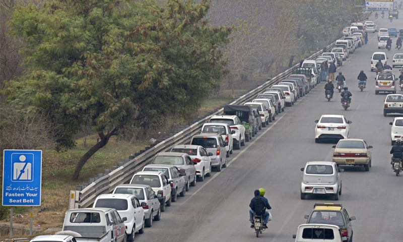 Vehicles queue up on Islamabad Expressway to get their M-Tags at the Kachnar Park registration centre in I-8 sector on Wednesday. &mdash; White Star