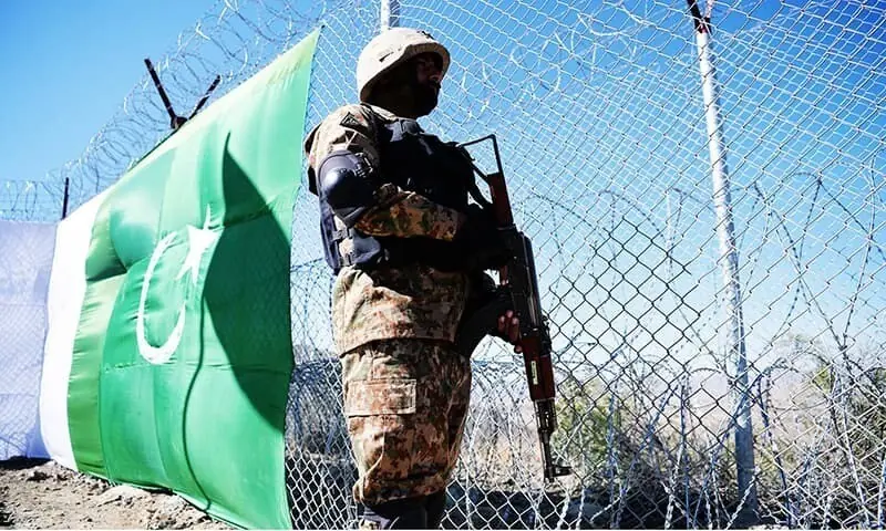 A Pakistani soldier keeps vigil next to a newly fenced border along Afghanistan. — AFP/File A Pakistani soldier keeps vigil next to a newly fenced border along Afghanistan. — AFP/File