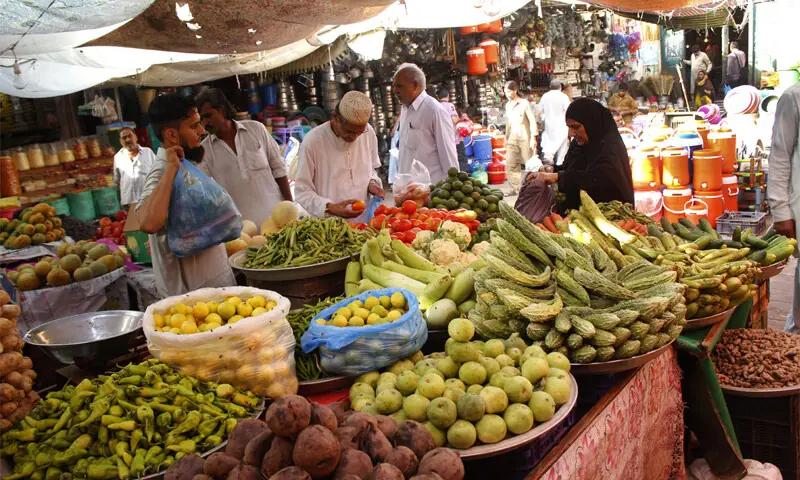 In this file photo, people buy vegetables from Karachi&rsquo;s Empress Market. &mdash; Photo by Shahab Nafees/File