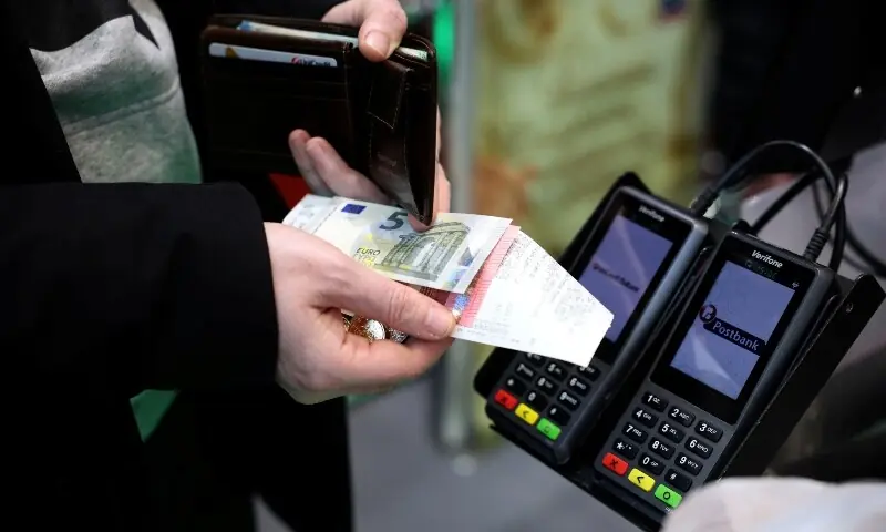 A person receives change in euros as they shop in Fantastico store, on the day of the country’s accession to the Eurozone, in Sofia, Bulgaria, January 1. — Reuters A person receives change in euros as they shop in Fantastico store, on the day of the country’s accession to the Eurozone, in Sofia, Bulgaria, January 1. — Reuters