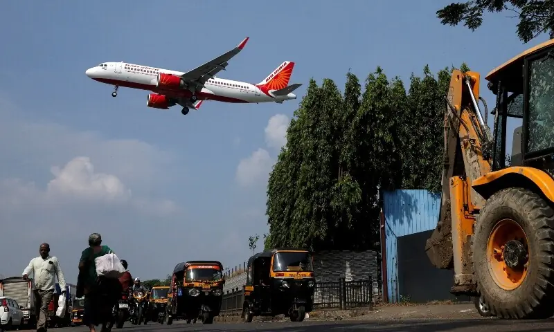 An Air India aircraft flies low as it prepares to land in Mumbai, India, October 22, 2025. &mdash; Reuters