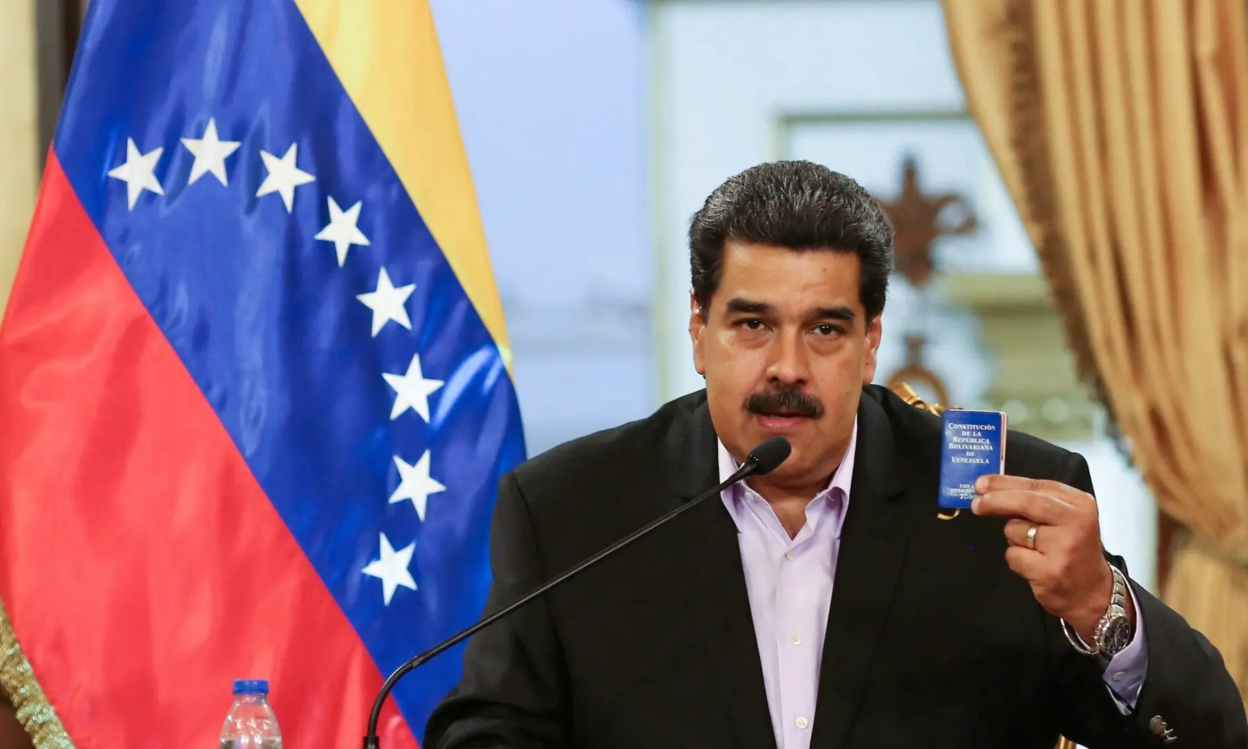 FILE PHOTO: Venezuela&rsquo;s President Nicolas Maduro holds a copy of the Venezuelan constitution while he speaks during a meeting with members of the Venezuelan diplomatic corp after their arrival from the United States, at the Miraflores Palace in Caracas, Venezuela January 28, 2019.