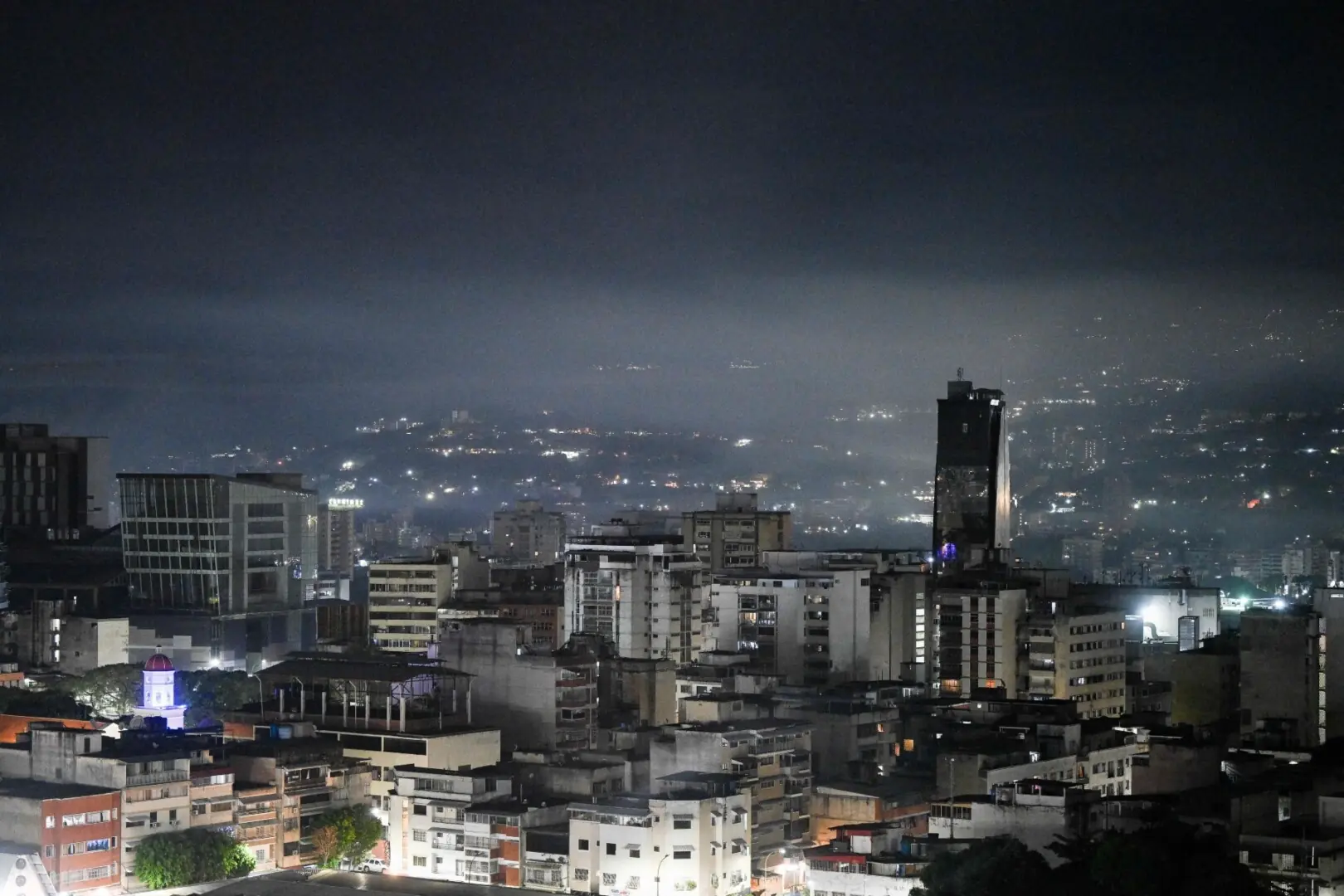Night view of Caracas taken after a series of explosions heard on January 3, 2026. — AFP