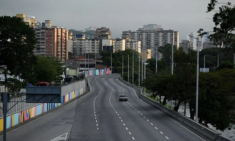 A car drives on an empty street, after US President Donald Trump said the US has struck Venezuela and captured its President Nicolas Maduro, in Caracas, Venezuela January 3, 2026. &mdash;Reuters