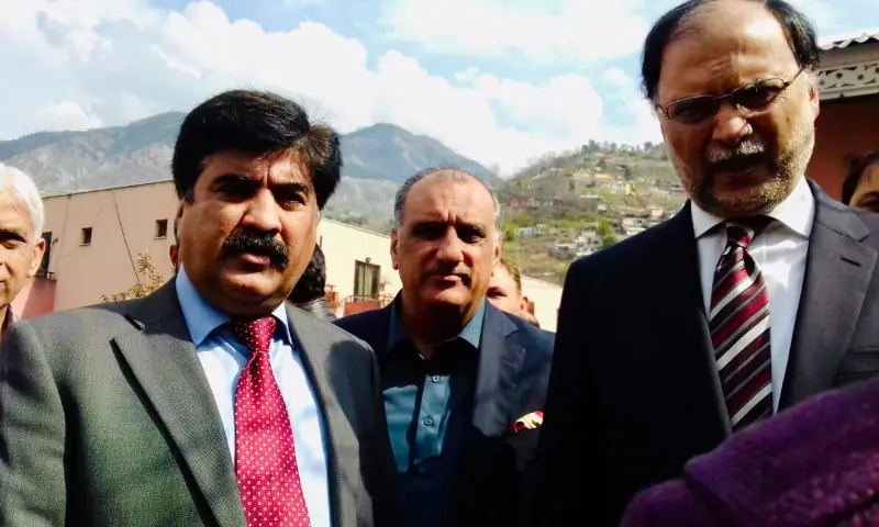 In this file photo, PML-N manifesto committee member Shahid Mahmood Wani (left) speaks to Ahsan Iqbal, federal minister for planning, in Muzaffarabad. AJK&rsquo;s former health minister Dr Najeeb Naqi is also seen in the centre. &mdash; Photo via author