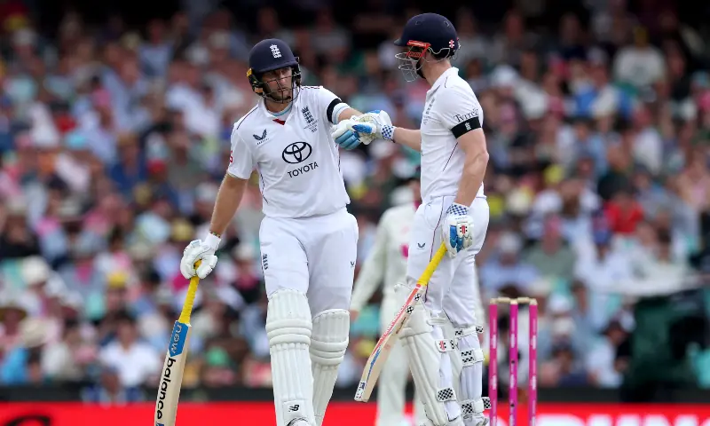 England&rsquo;s Joe Root (L) and Harry Brook touch gloves on day one of the fifth Ashes cricket Test match between Australia and England at the Sydney Cricket Ground (SCG) in Sydney on January 4, 2026. &mdash; AFP