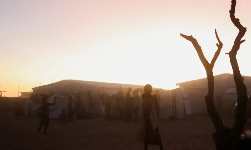 Sudanese refugees from El Fasher gather at sunset in the Tine transit camp amid the conflict between the paramilitary Rapid Support Forces (RSF) and the Sudanese Army, in eastern Chad on November 23, 2025. &mdash; Reuters
