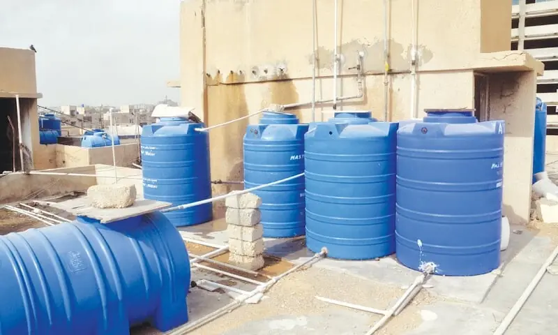 A leaking and stained overhead tank as opposed to the fibreglass water tanks./ Photos by Fahim Siddiqi / White Star/File