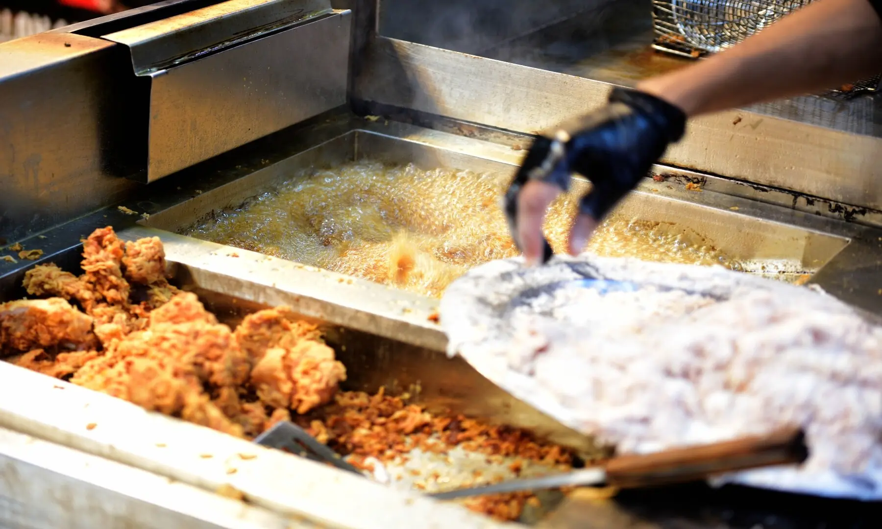 A vendor deep-fries chicken, preparing crispy, flavour-packed bites that have made them a favourite among Karachi&rsquo;s street food lovers. &mdash; Tahir Jamal/White Star